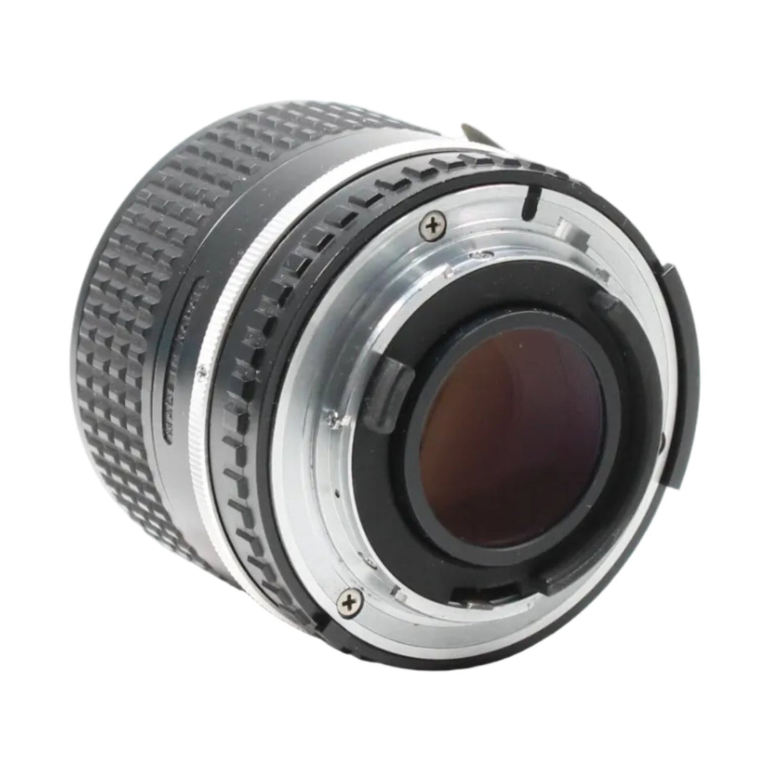 Rear view of black Nikon F-mount manual focus telephoto lens with silver mount ring and textured grip at ClubCamera.com