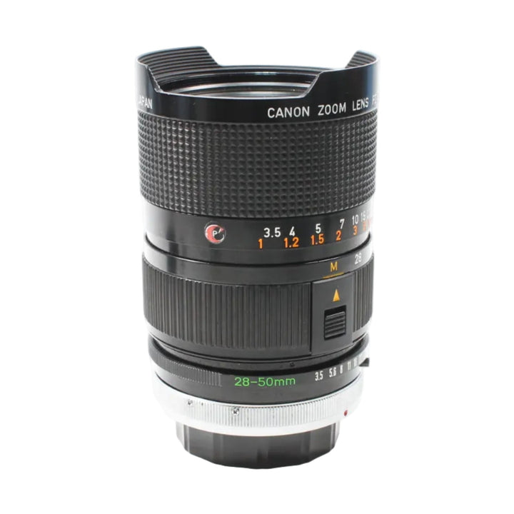 Front shot of black Canon FD 28-50mm zoom lens with textured grip and white lettering at ClubCamera.com