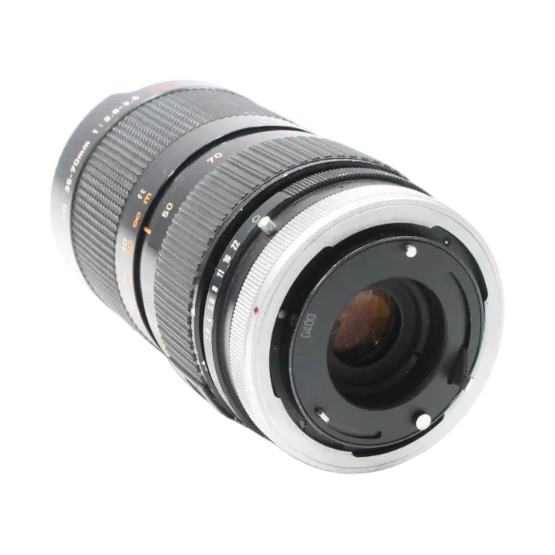 Rear mount view of Canon FD 35-70mm f/2.8-3.5 lens by ClubCamera highlighting silver metal interface and alignment pins