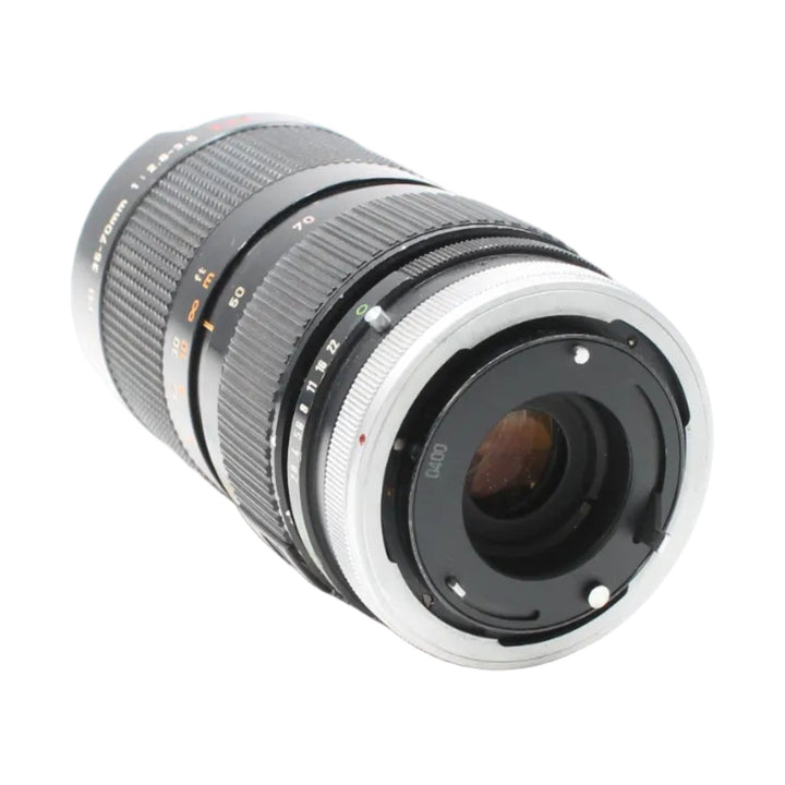 Rear mount view of Canon FD 35-70mm f/2.8-3.5 lens by ClubCamera highlighting silver metal interface and alignment pins