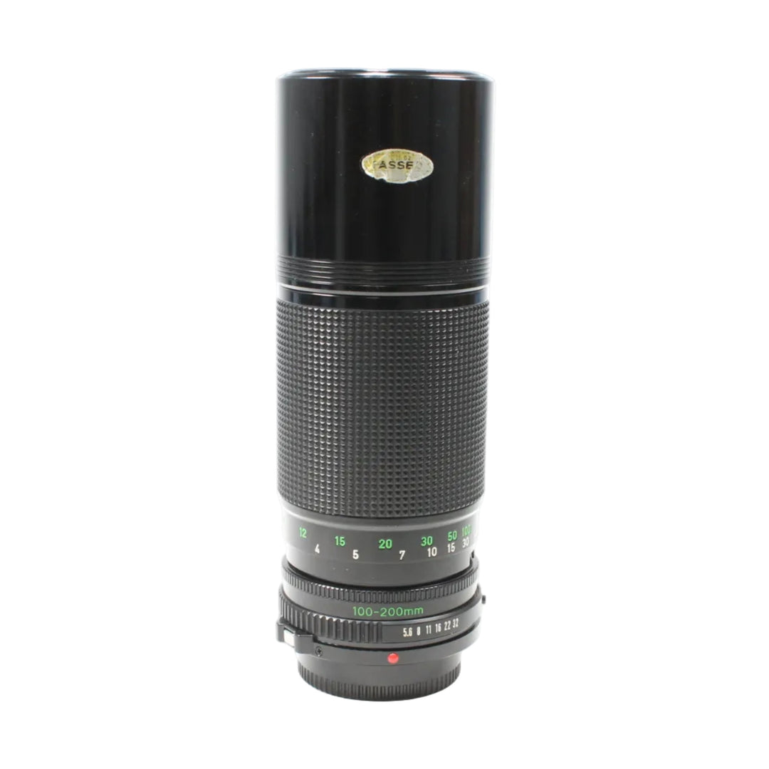 Black Canon FD 100-200mm f/5.6 MF lens from ClubCamera.com showing green focal length scale and diamond-pattern grip