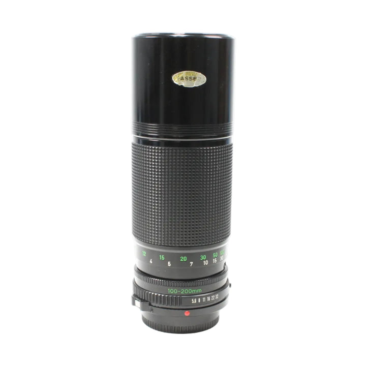 Black Canon FD 100-200mm f/5.6 MF lens from ClubCamera.com showing green focal length scale and diamond-pattern grip