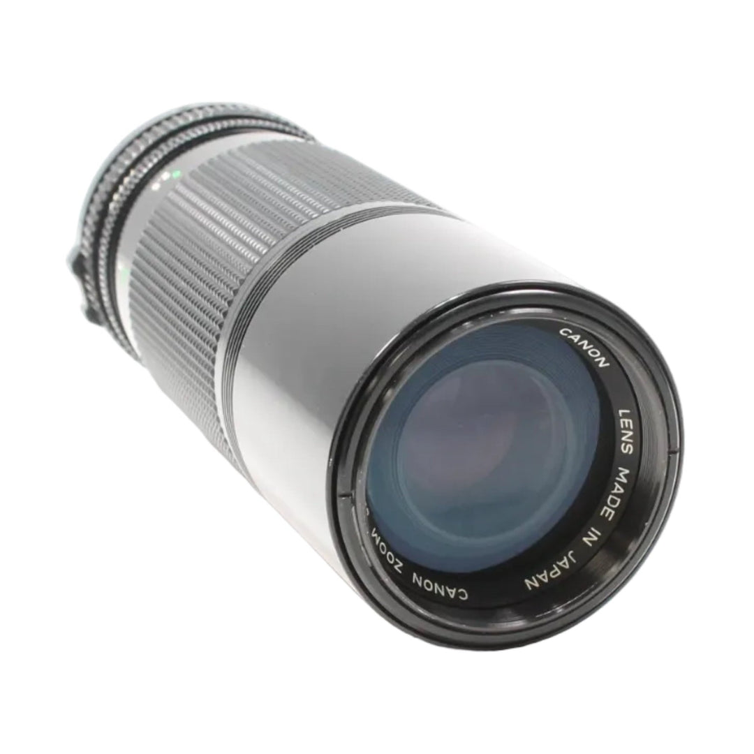 Canon FD 100-200mm f/5.6 manual focus telephoto zoom lens by ClubCamera.com with silver barrel and blue-tinted glass