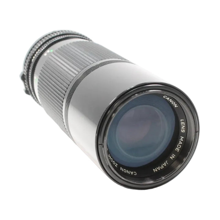 Canon FD 100-200mm f/5.6 manual focus telephoto zoom lens by ClubCamera.com with silver barrel and blue-tinted glass