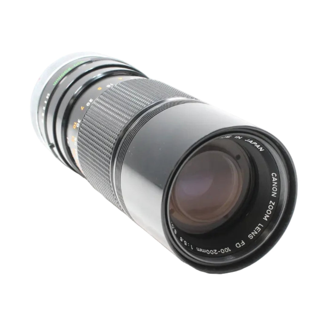 ClubCamera Canon FD 100-200mm f/5.6 telephoto lens front glass with purple coating and orange scale