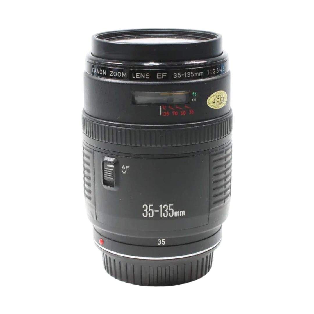 Canon EF 35-135mm autofocus lens detail shot highlighting focus distance scale and white labeling