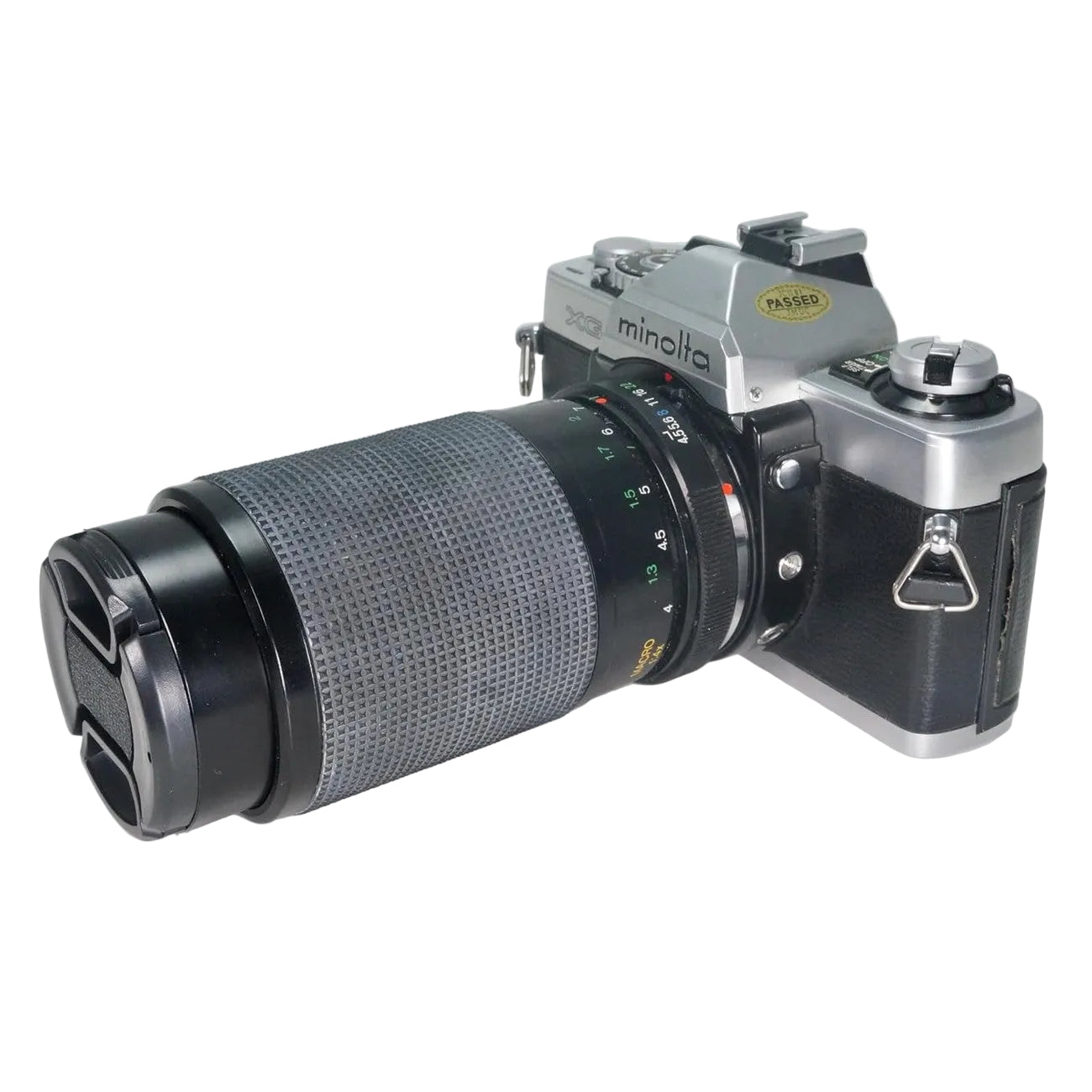 ClubCamera.com side angle of Minolta XG-1 35mm SLR with diamond-textured focus ring and tested passed sticker