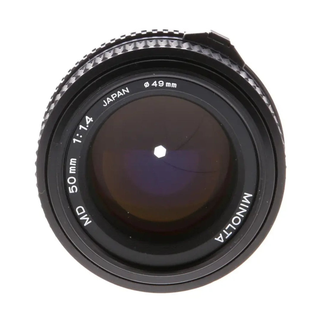 ClubCamera.com front view of Minolta 50mm f/1.4 MD lens showing purple coating and engraved specs