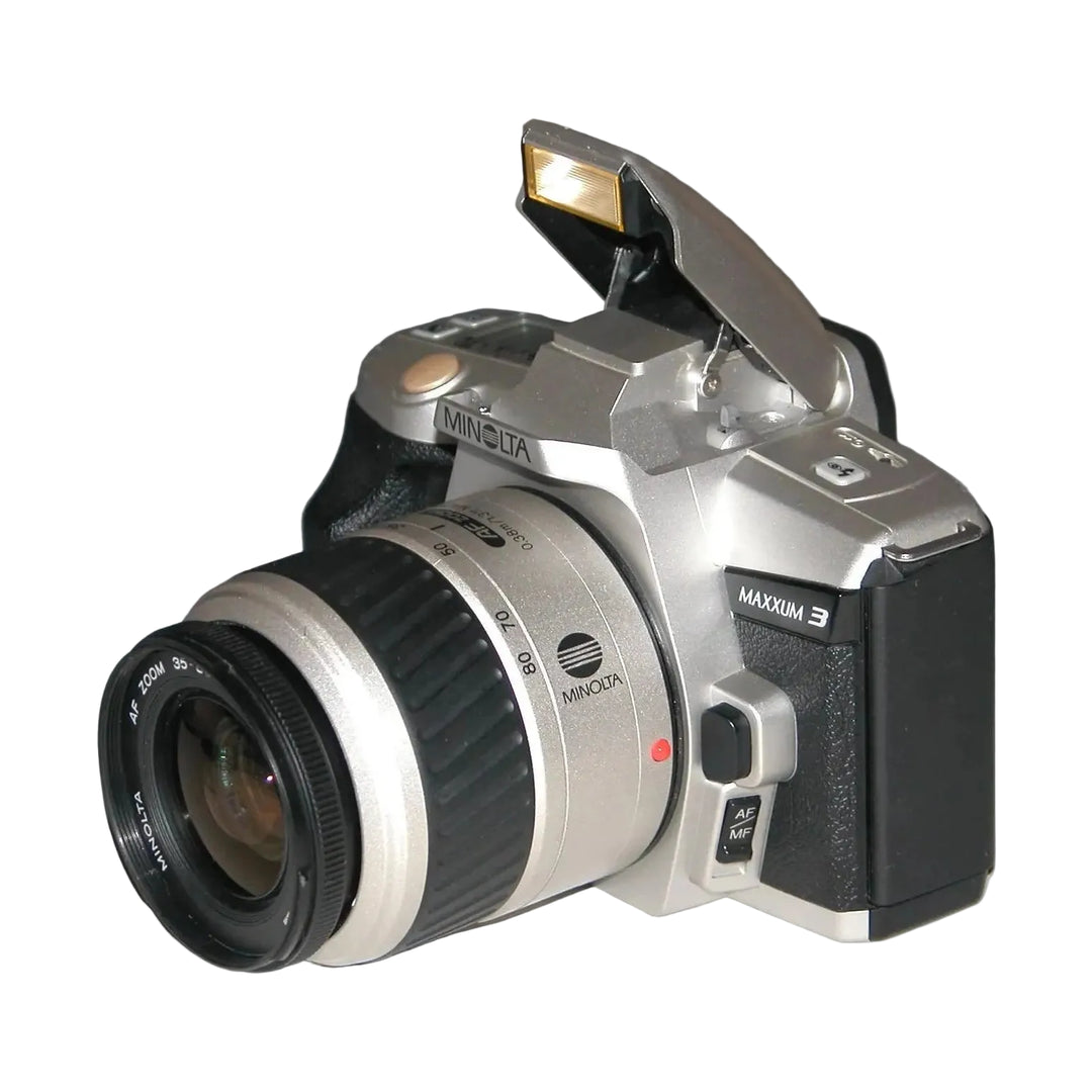 Minolta Maxxum 3 SLR film camera kit with AF Zoom lens at ClubCamera.com showing raised flash and silver black body