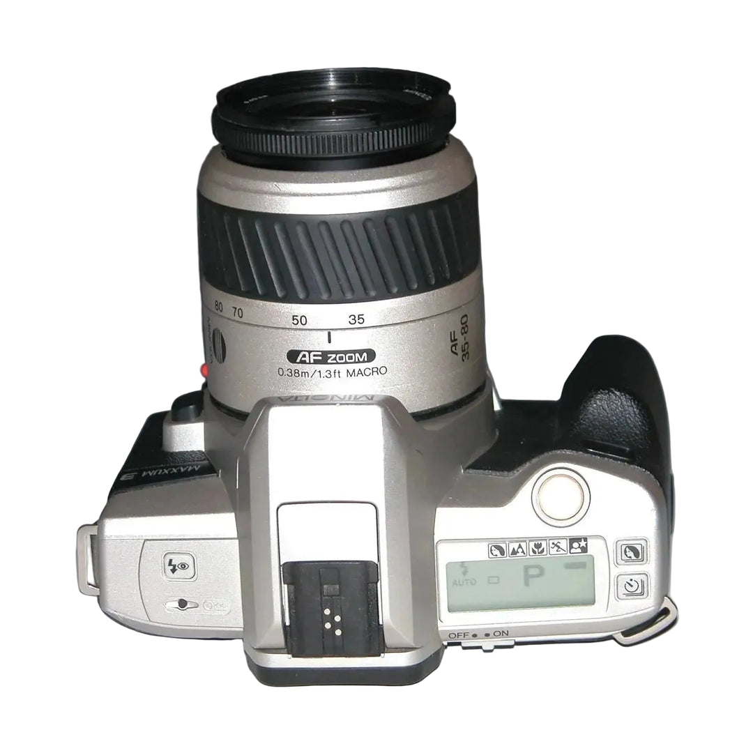 Top view of Minolta Maxxum 3 SLR camera controls LCD P mode and focus ring at ClubCamera.com