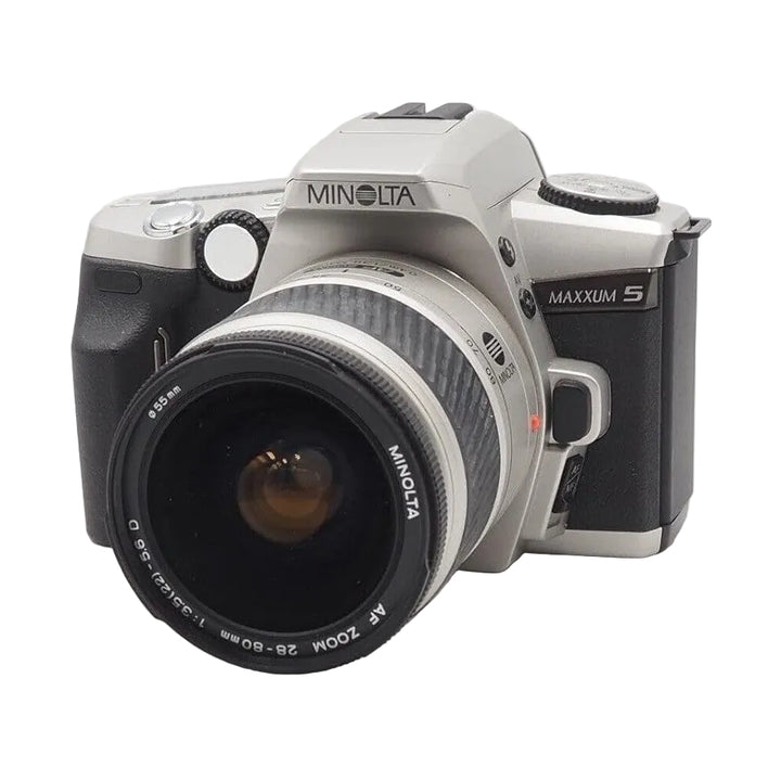 Front three-quarter Minolta Maxxum 5 film SLR with 28-80mm AF zoom lens and silver top plate at ClubCamera.com