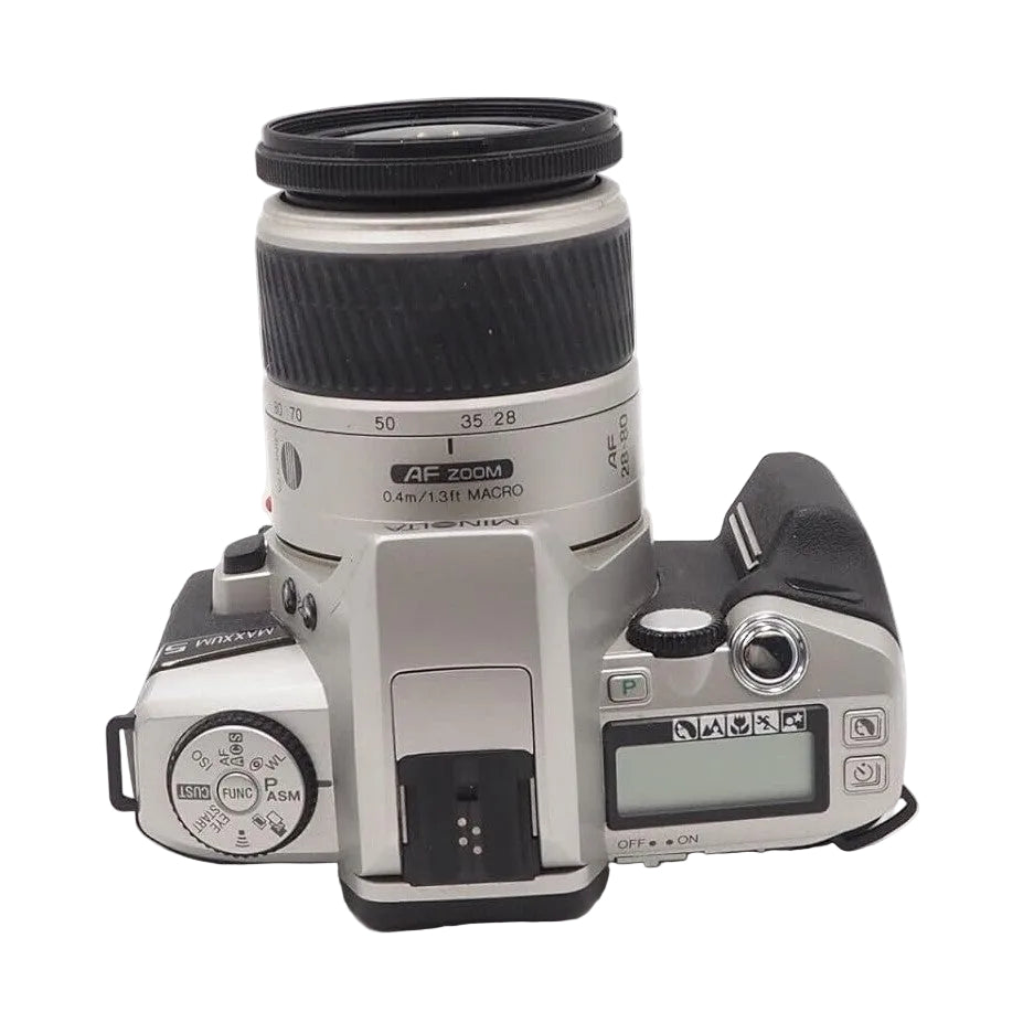 Top-down angled Minolta Maxxum 5 with AF Zoom 28-80mm lens showing mode dial and LCD screen from ClubCamera.com