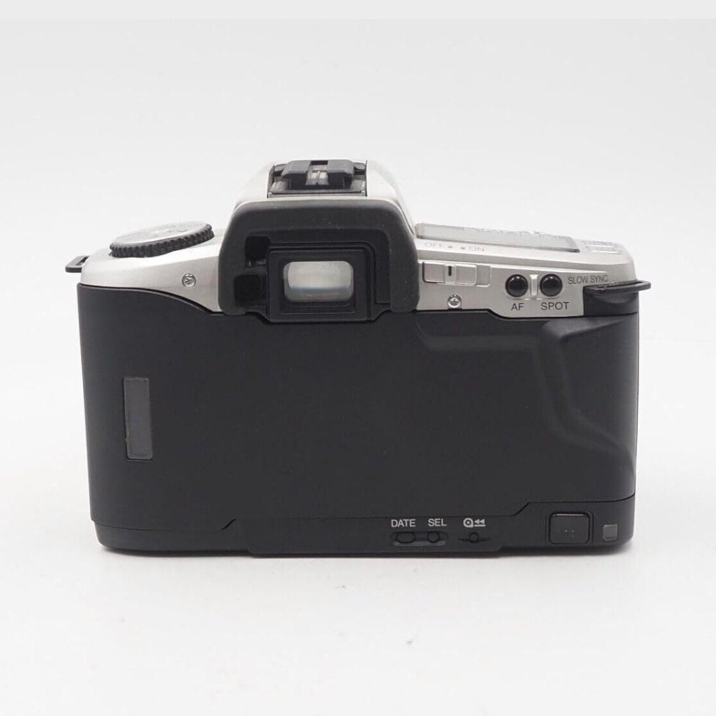 Rear view silver and black Minolta Maxxum 5 SLR film camera with textured grip and control buttons at ClubCamera.com