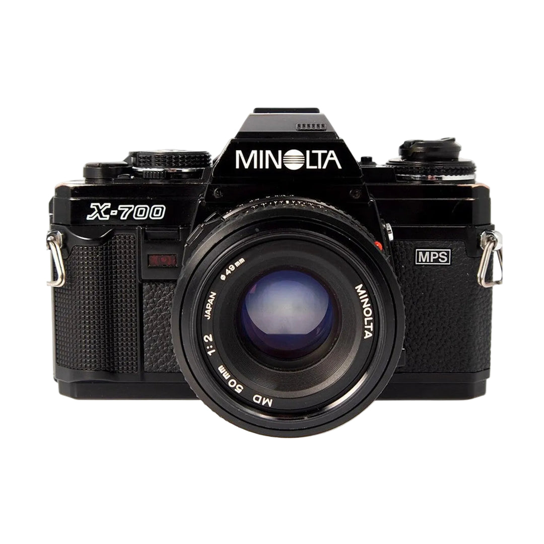 ClubCamera.com black Minolta X-700 SLR film camera with mounted MD 50mm f/2 lens front view showing aperture ring