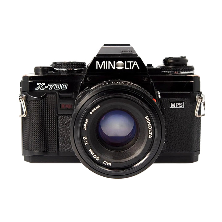 ClubCamera.com black Minolta X-700 SLR film camera with mounted MD 50mm f/2 lens front view showing aperture ring