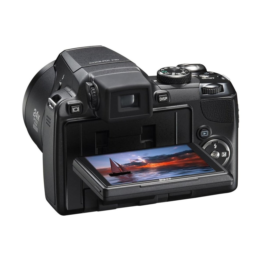 ClubCamera.com black Nikon COOLPIX P90 rear view with extended tilting LCD screen displaying sunset seascape and EVF housing