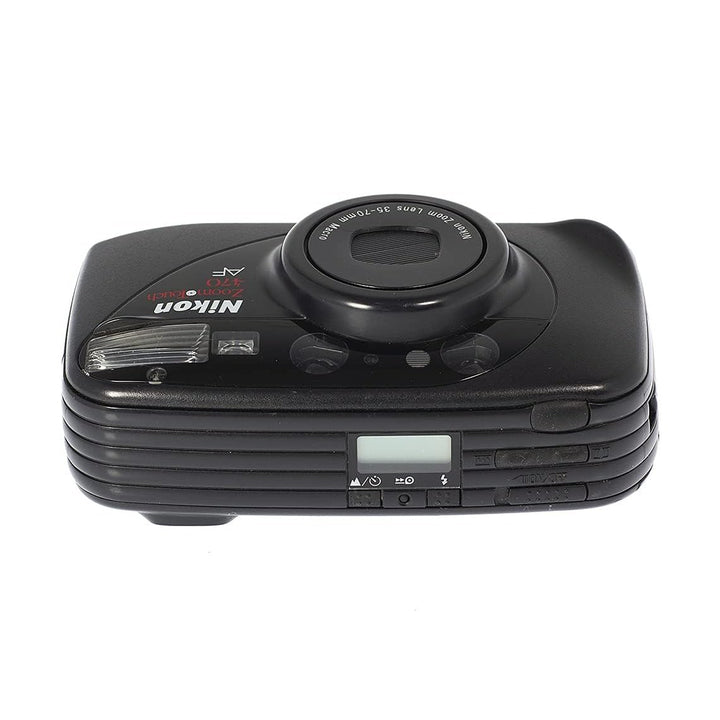 Top view of black Nikon ZoomTouch 470 AF point-and-shoot showing shutter button, LCD screen, and control buttons from ClubCamera.com