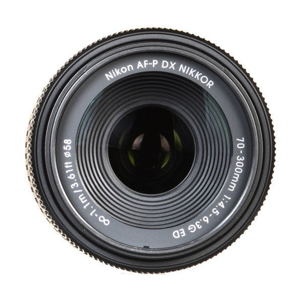 Top-down close-up of Nikon AF-P DX 70-300mm front element rim text and focus ring at ClubCamera.com