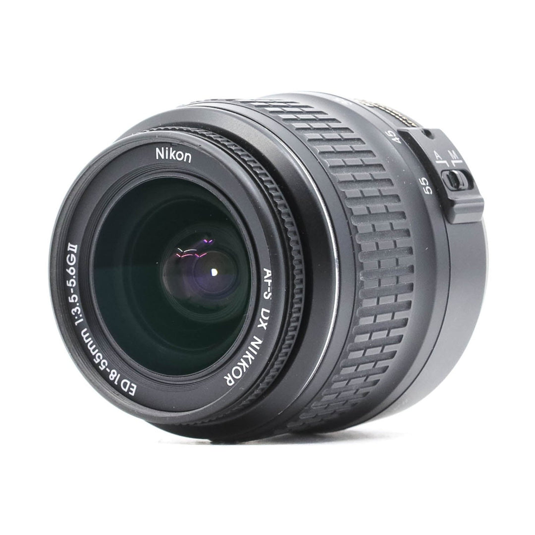 Diagonal angle of black Nikon 18-55mm DX zoom lens showing focus ring and glossy finish at ClubCamera.com
