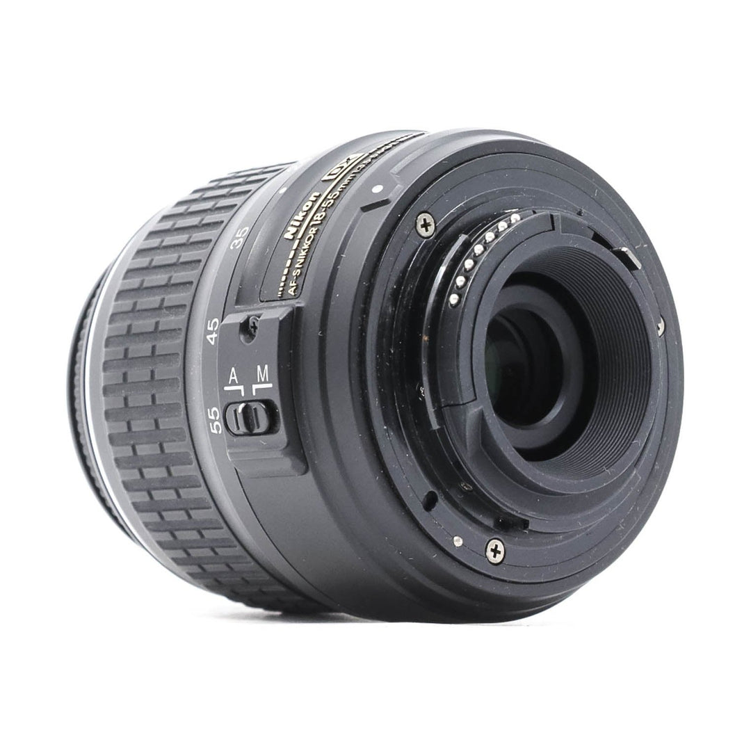 Rear mount view of Nikon AF-S DX 18-55mm lens revealing electrical contacts and alignment pins at ClubCamera.com