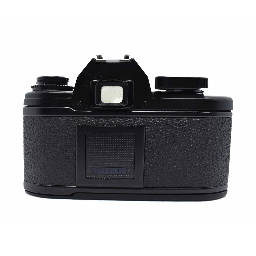 Back view of black Nikon EM SLR film camera with rewind crank and serial number from ClubCamera.com