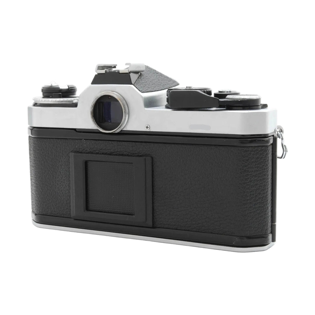 Rear view of black leatherette Nikon FE2 SLR film camera by ClubCamera.com highlighting rewind crank and eyepiece