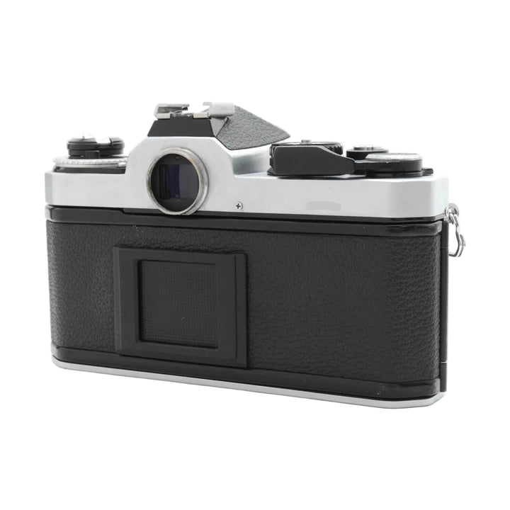 Rear view of black leatherette Nikon FE2 SLR film camera by ClubCamera.com highlighting rewind crank and eyepiece