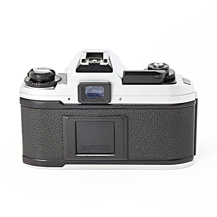 Back view of Nikon FG-20 35mm SLR film camera with optical viewfinder and hot shoe mount by ClubCamera.com