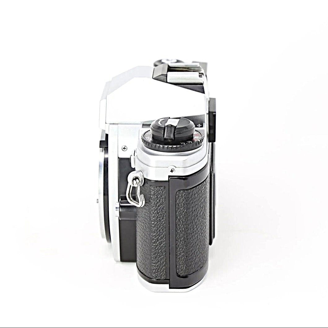 Nikon FG-20 rear angle view showing rewind crank and rubberized grip on silver body from ClubCamera.com