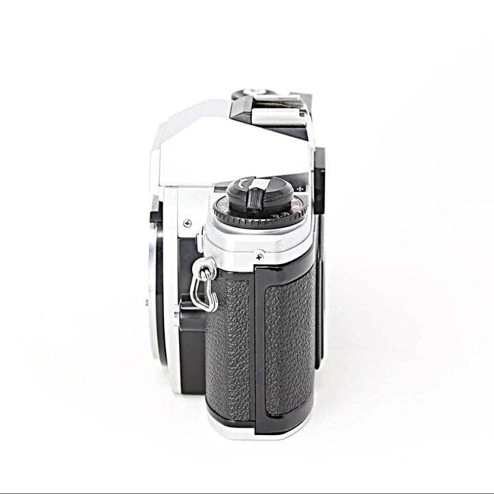 Nikon FG-20 rear angle view showing rewind crank and rubberized grip on silver body from ClubCamera.com