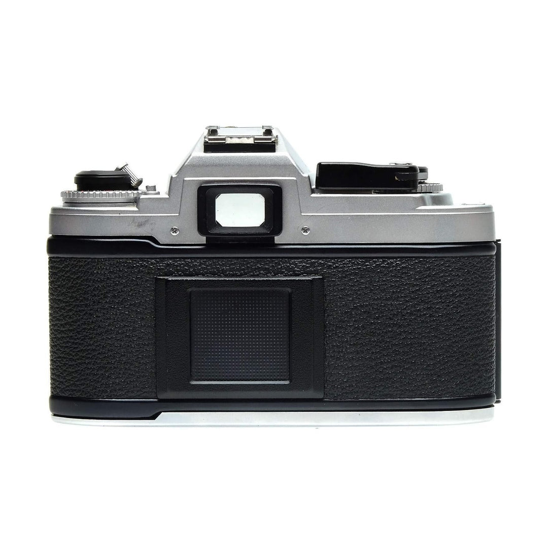 Top view of silver Nikon FG rear panel with rewind crank and battery cover at ClubCamera.com