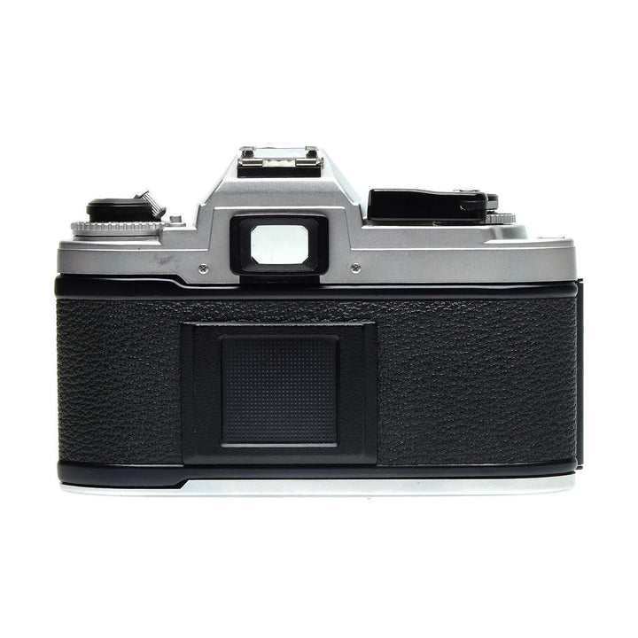 Top view of silver Nikon FG rear panel with rewind crank and battery cover at ClubCamera.com