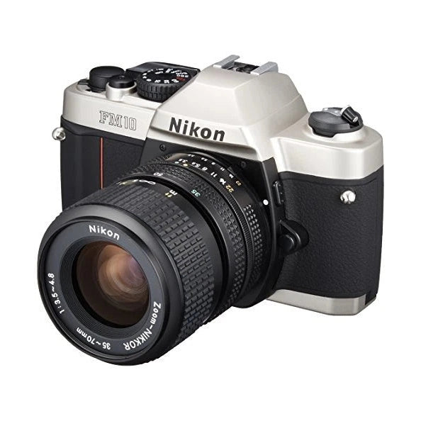 Front-three-quarter angle of retro silver and black Nikon FM-10 35mm SLR film camera kit with textured grip and Nikkor 35-70mm lens from ClubCamera.com