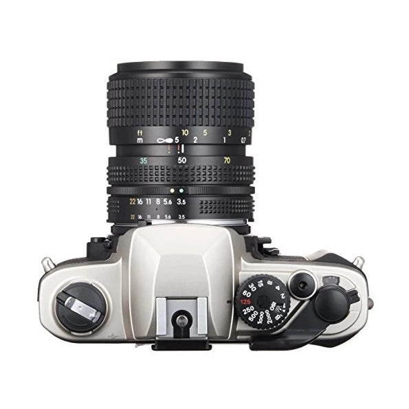 Top-down view of silver and black Nikon FM-10 SLR film camera with manual shutter speed dials and Nikkor zoom lens at ClubCamera.com