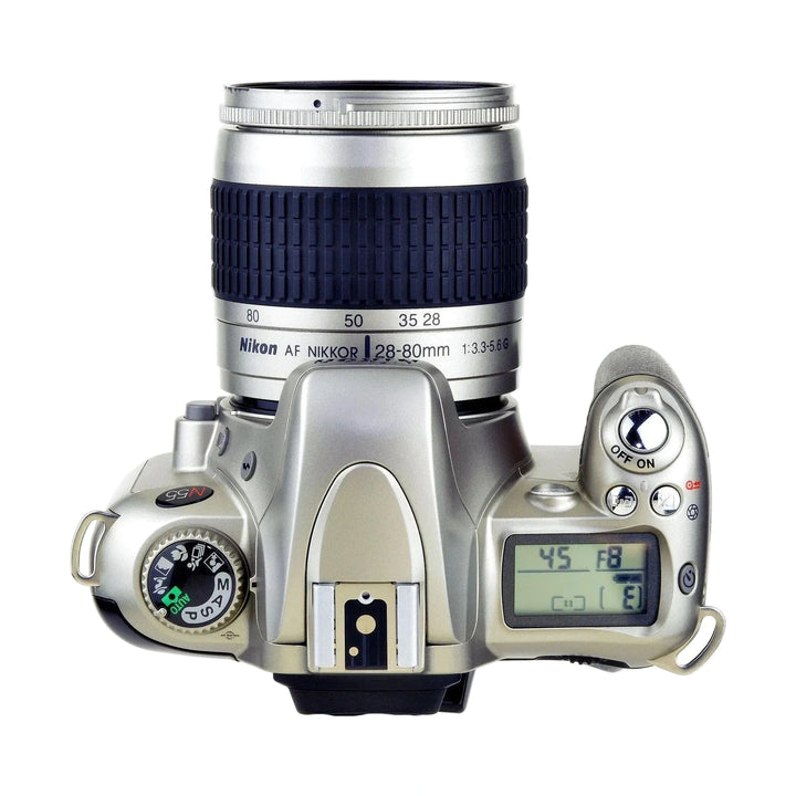 Top-down silver Nikon N55 SLR film camera kit with AF Nikkor 28-80mm lens at ClubCamera.com showing mode dial and LCD