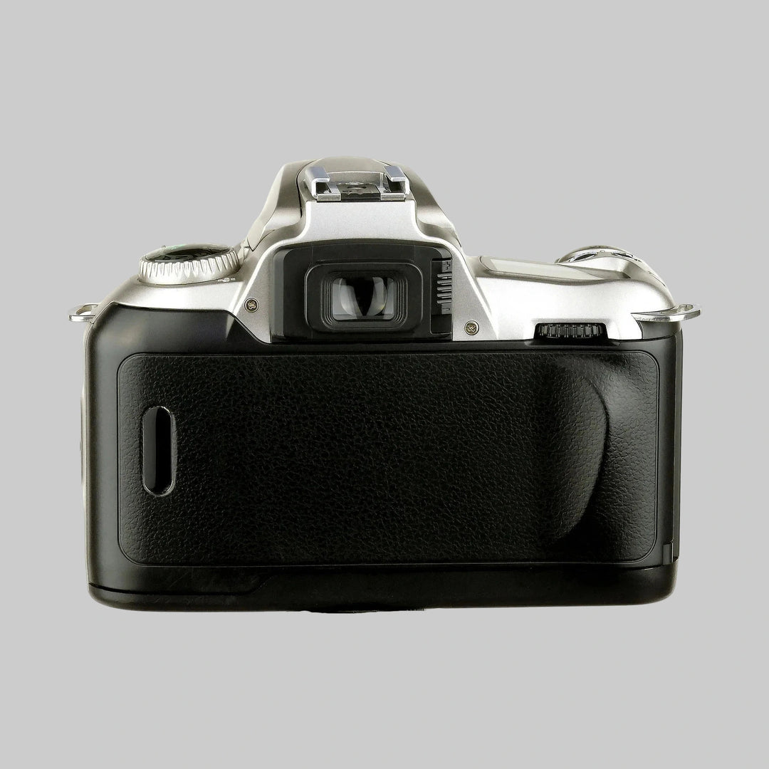 Rear view of silver Nikon N55 SLR film camera with textured pebbled grip, viewfinder eyepiece, and hot shoe at ClubCamera.com