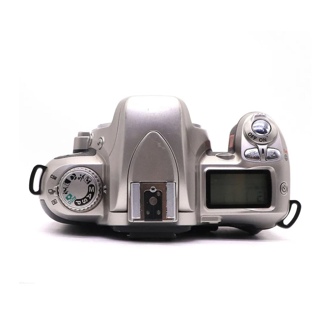Top control layout of silver Nikon N75 SLR film camera with LCD screen at ClubCamera.com