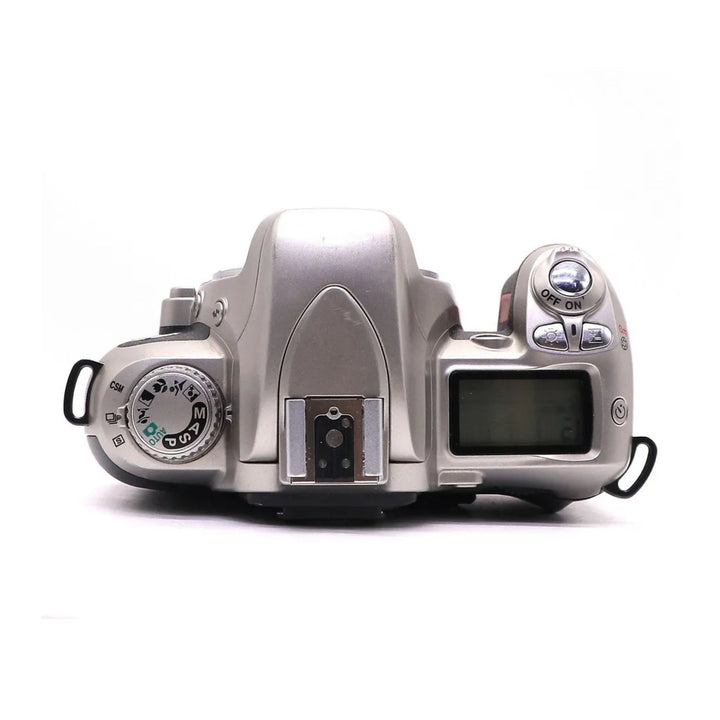Top control layout of silver Nikon N75 SLR film camera with LCD screen at ClubCamera.com