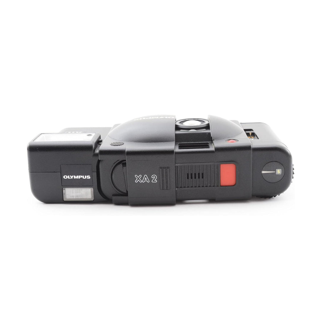 Black Olympus XA 2 rear view with red shutter button and mode dial from ClubCamera.com