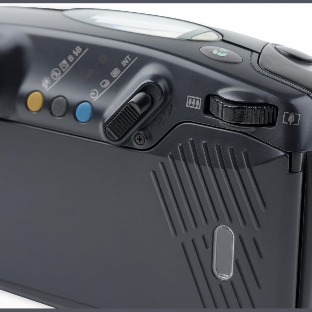 ClubCamera.com detailed top-left cluster of black Pentax Zoom 105R featuring yellow sunburst and blue INT buttons