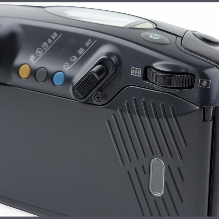 ClubCamera.com detailed top-left cluster of black Pentax Zoom 105R featuring yellow sunburst and blue INT buttons