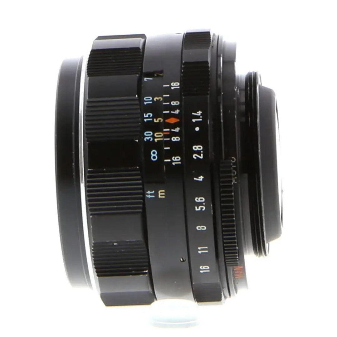 Side view of Pentax 50mm f/1.4 manual focus lens showing distance scale and aperture ring markings for ClubCamera.com