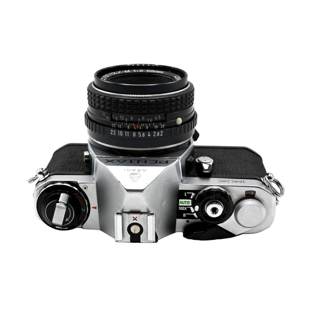 Pentax ME film camera bottom-up view of hot shoe mount and AUTO mode selector dial with 50mm lens at ClubCamera.com