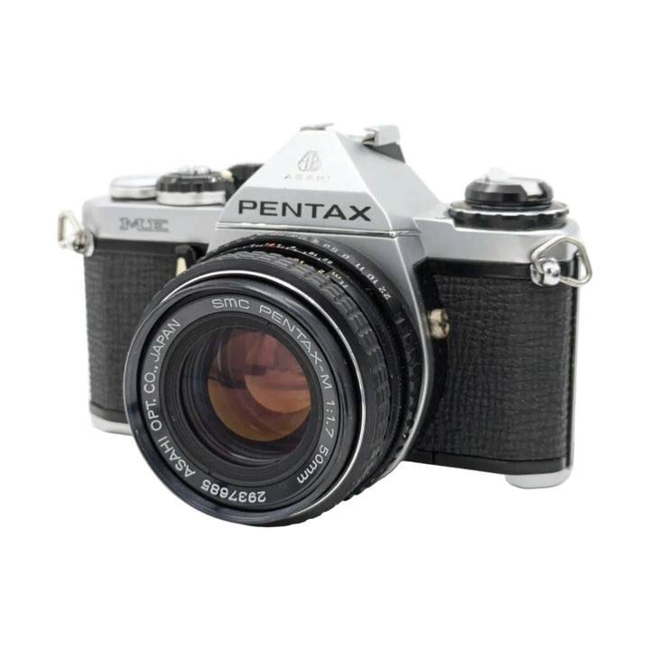 ClubCamera.com front three-quarter view of silver Pentax ME manual focus SLR camera with SMC Pentax-M 50mm lens and chrome shutter dial