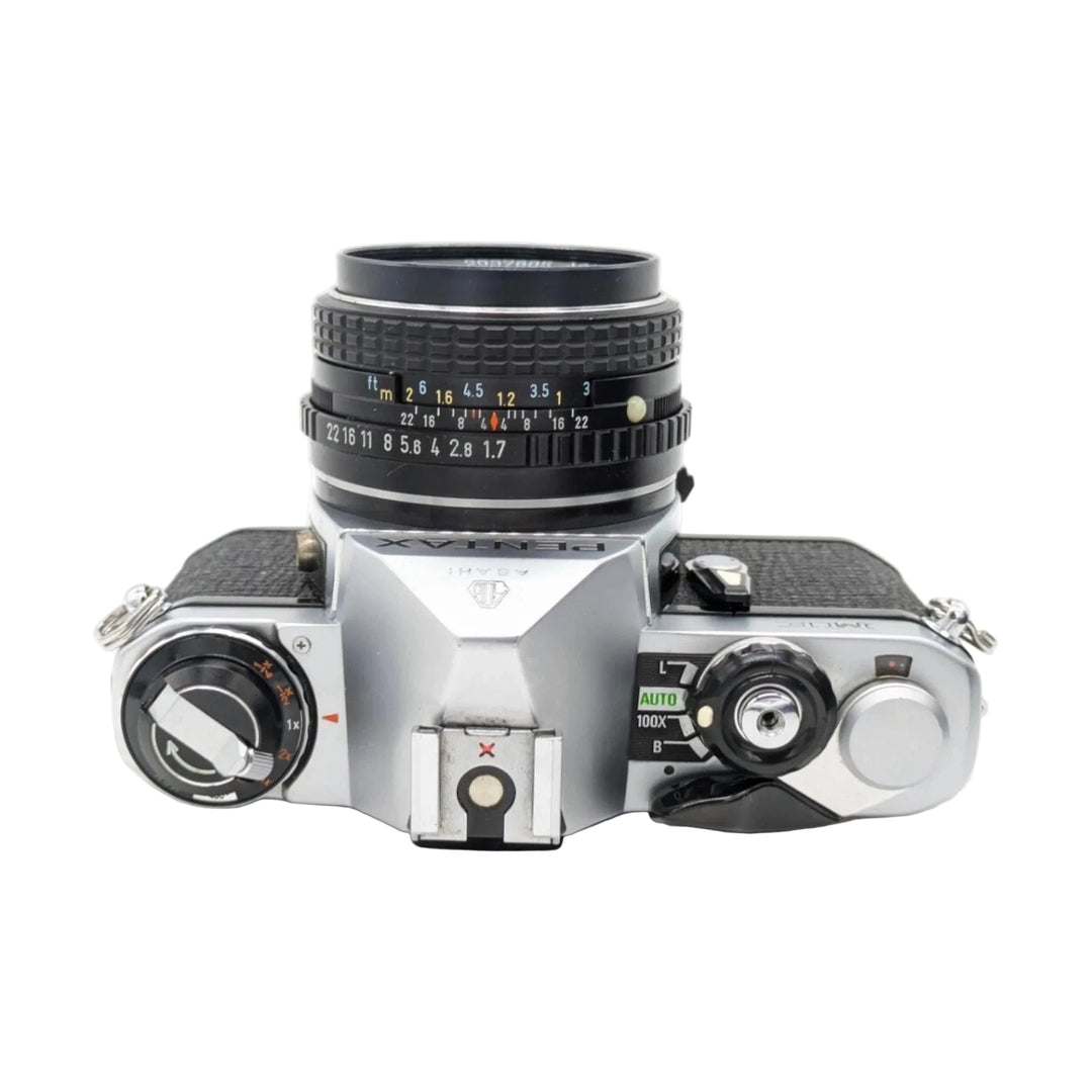 ClubCamera.com top-down view of silver Pentax ME SLR with SMC Pentax-M 50mm f/1.7 lens showing mode dial and exposure controls