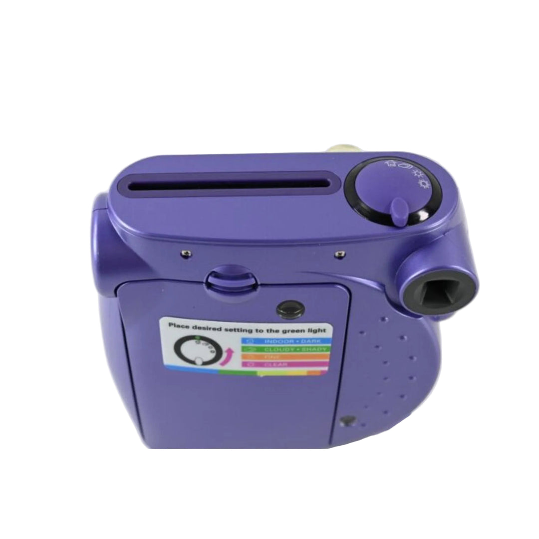 Top front angle of purple Polaroid 300 film camera showing flash dial and eject slot at ClubCamera.com