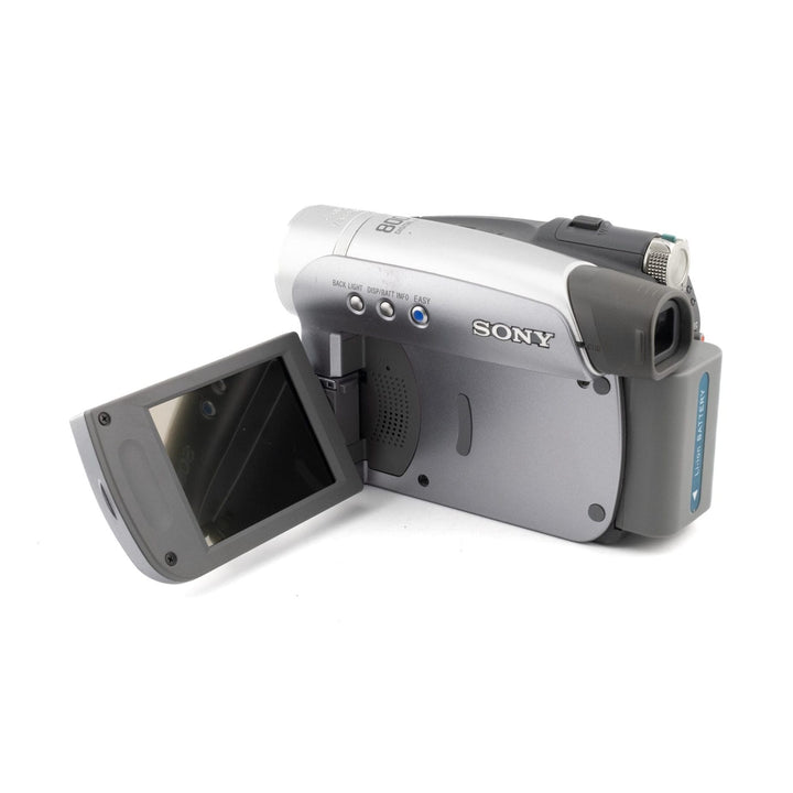 ClubCamera.com silver Sony Handycam DCR-HC28 with flip-out LCD screen, lithium battery pack, and control buttons