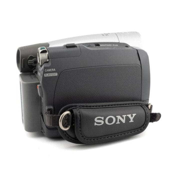 ClubCamera.com side-rear view of black Sony DCR-HC28 camcorder highlighting rubberized grip and Super SteadyShot Plus dial