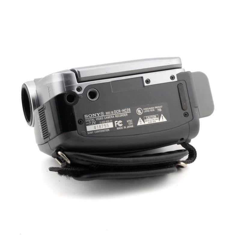 ClubCamera.com rear view of silver and black Sony DCR-HC28 MiniDV camcorder with textured grip and regulatory labels