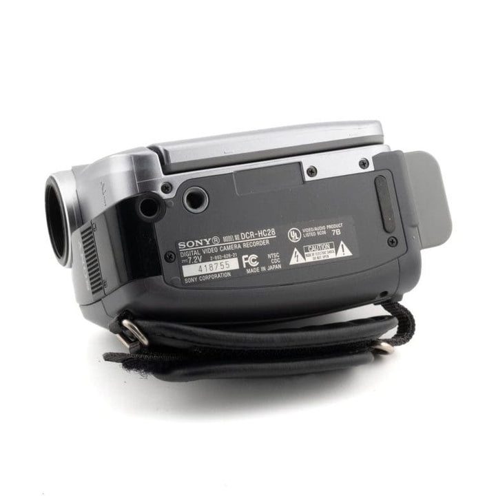 ClubCamera.com rear view of silver and black Sony DCR-HC28 MiniDV camcorder with textured grip and regulatory labels